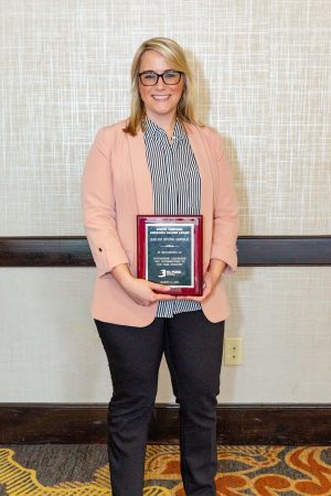 Bailee Arnold holding Emerging Leader award